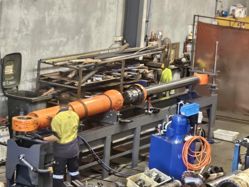 Matchtec technician repairing a hydraulic cylinder in the workshop
